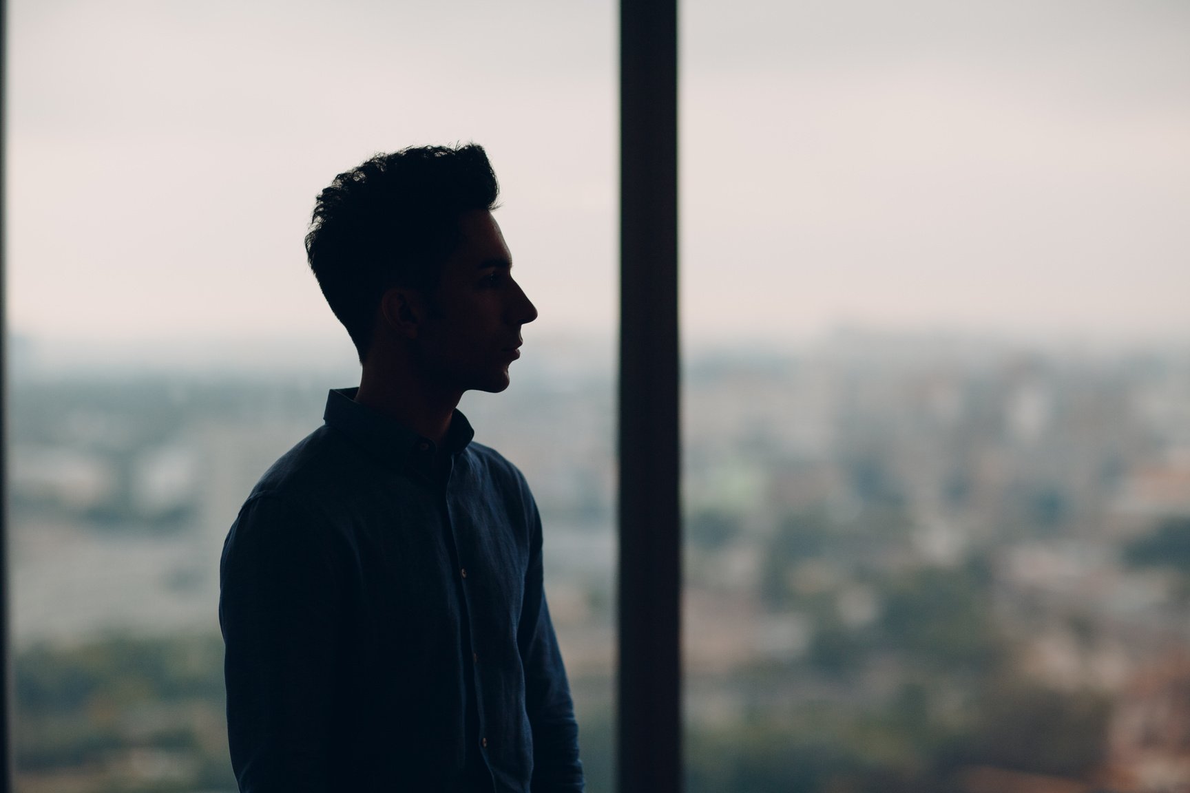 Young male profile portrait against window